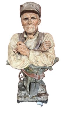 a statue of an old man with a hat on his head
