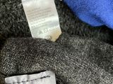 the label is on the sweater of a person ' s hand
