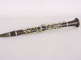 a black and gold pen sitting on top of a white table