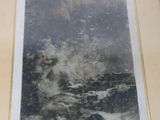framed picture of a painting of a rock in the middle of a body of water
