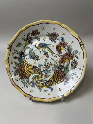 a close up of a plate with flowers and birds on it