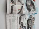 an open magazine with a picture of a car and a picture of a car
