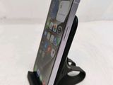 a close up of a cell phone on a stand on a table