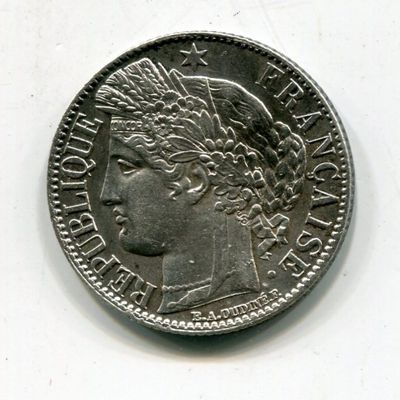 an old coin with a woman ' s head on it on a white surface