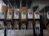 many containers of cereal on a shelf in a store