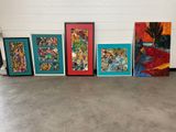 five framed paintings of different colors on the wall