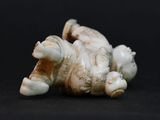 a picture of a figurine of a baby elephant laying on its back