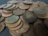 a pile of coins sitting on a table with a black background