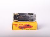 a red toy car sitting on top of a yellow box