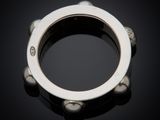 a close up of a silver ring on a black surface