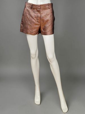 a mannequin mannequin wearing a white top and brown shorts