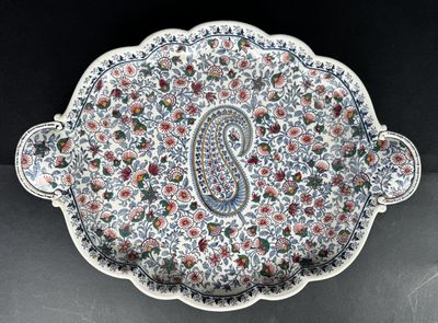 a close up of a plate with a paisley design on it