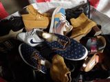 many pairs of shoes in a bag on the floor