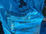 a blue bag of food sitting on the ground