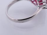 a close up of a ring with a pink stone in it
