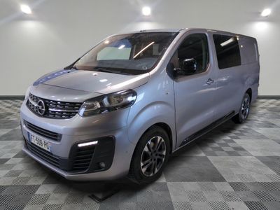 the silver van is parked on a checkered tile floor
