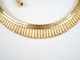 an image of a gold necklace and a pair of earrings