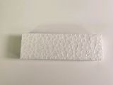 a close up of a piece of paper on a white surface
