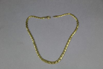 a gold chain on a white background