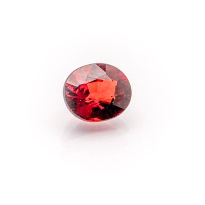 a red garnet stone on a white background