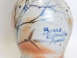 a ceramic vase with a blue and white design on it