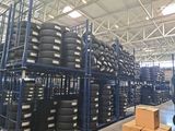 a man that is standing in front of a rack full of tires