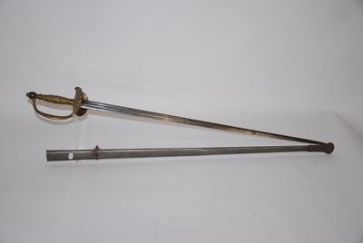 an old sword with a metal handle on a white surface