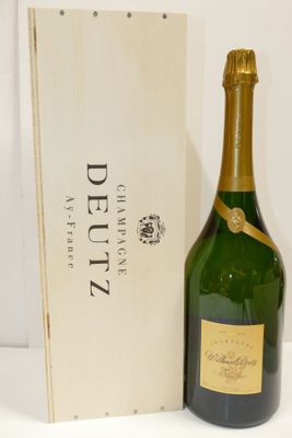 a bottle of champagne and a wooden box on a white surface