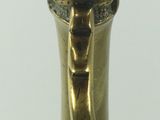 a close up of a brass object on a white surface