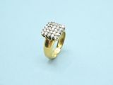 a close up of a gold ring with diamonds on a blue surface