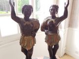 two statues of a boy and a girl on top of a table