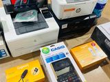 many different types of printers and calculators on the table
