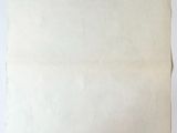 an old piece of paper sitting on top of a wooden table