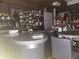 an image of a bar with a lot of bottles on the counter