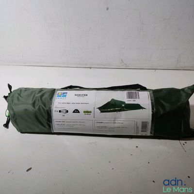 a roll of fabric on the floor next to a bag