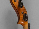 a close up of a violin on a gray background