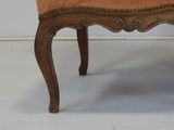 a chair that has been upholstered with an orange upholstered seat