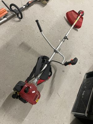 a picture of a string trimmer and a corded edger in a garage