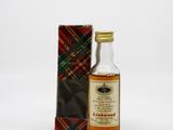 an image of a bottle of whisky sitting next to a box