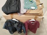a pile of clothes sitting on top of a cardboard box