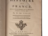 an open book with a picture of a crown on top of it