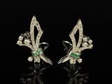 a pair of emerald and diamond earrings