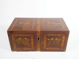 an old wooden box with a floral design on the front