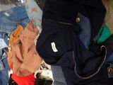a pile of clothes on a bed in a room