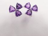 a pair of purple amethorate earrings on a white background