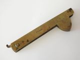 an old brass plate with a handle on a white surface