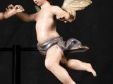 a statue of two angels holding hands with a black background