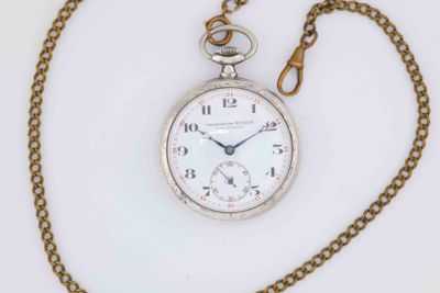 a silver pocket watch with a chain on a white surface