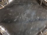 an antique silver plate with a monogram on it