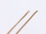 gold plated chain with a heart pendant on a white background